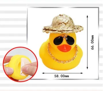 Straw hat yellow duck car ornament with adhesive gel and miniature sunglasses accessory on car dashboard