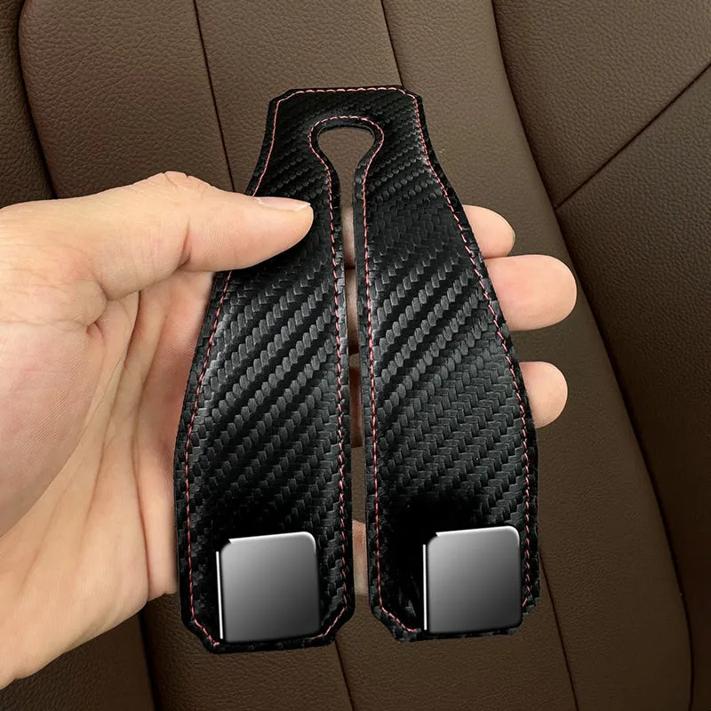 Black carbon fibre metal car hook clipped to headrest with 25kg load capacity