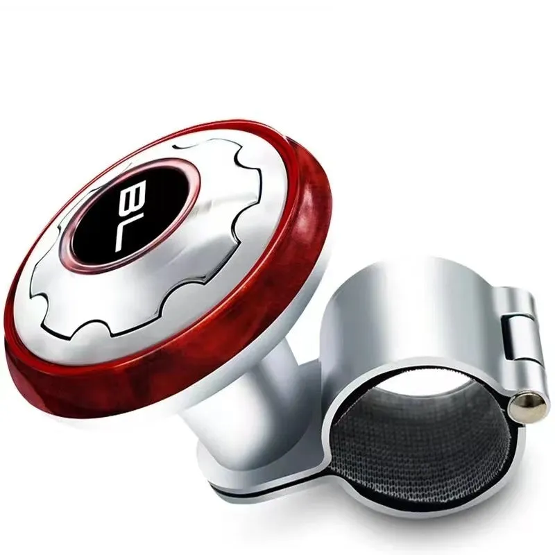 Metal universal steering wheel assist ball with steel ball bearing in silver finish mounted on a car steering wheel for one-handed control