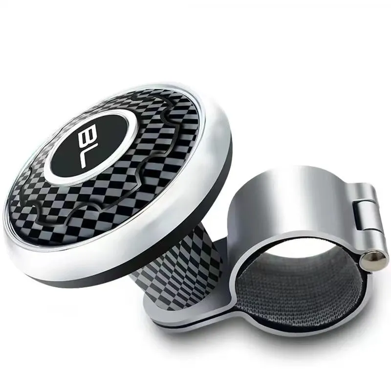 Metal universal steering wheel assist ball with steel ball bearing in silver finish mounted on a car steering wheel for one-handed control