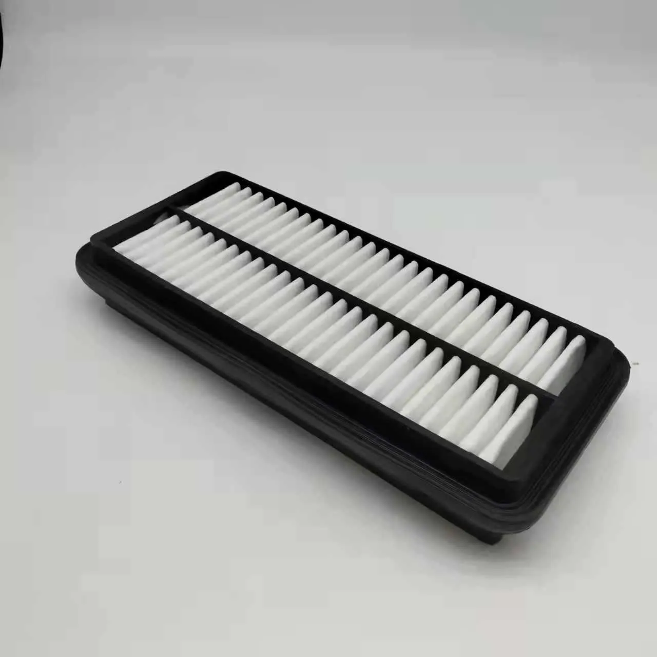 Black rectangular car air filter measuring 256mm by 113mm by 40mm.
