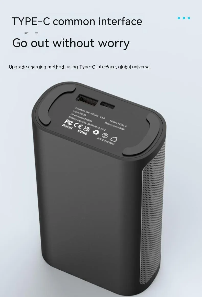 Black handheld wireless digital tyre inflator with LCD screen, LED light and multiple nozzle attachments on a table.