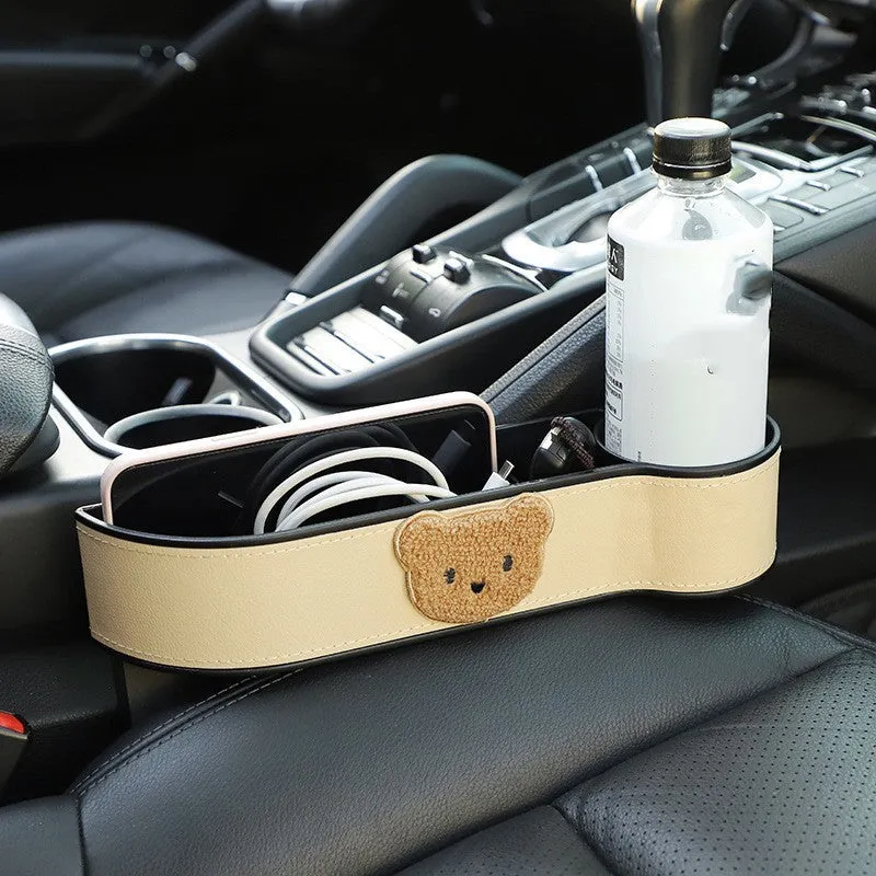 Leather car seat gap storage box with cartoon bear design hanging between vehicle seats