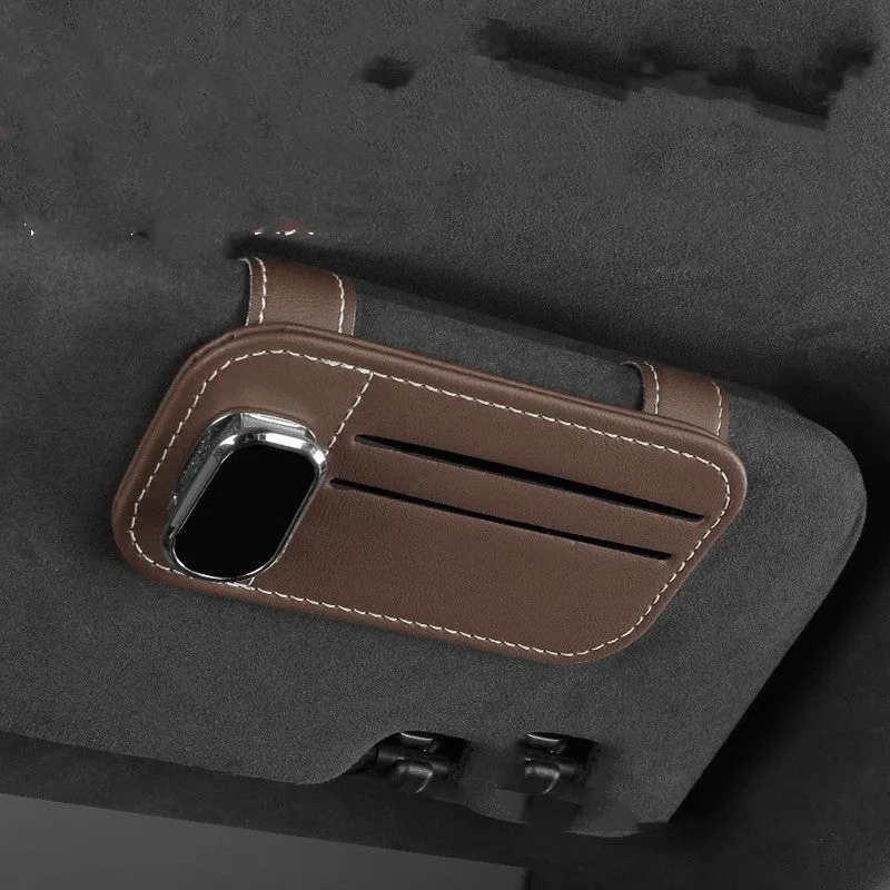 Beige leather car sun visor organiser holding cards and a pair of sunglasses.