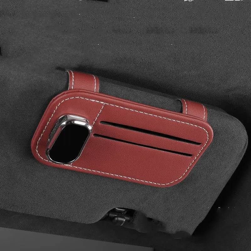 Beige leather car sun visor organiser holding cards and a pair of sunglasses.
