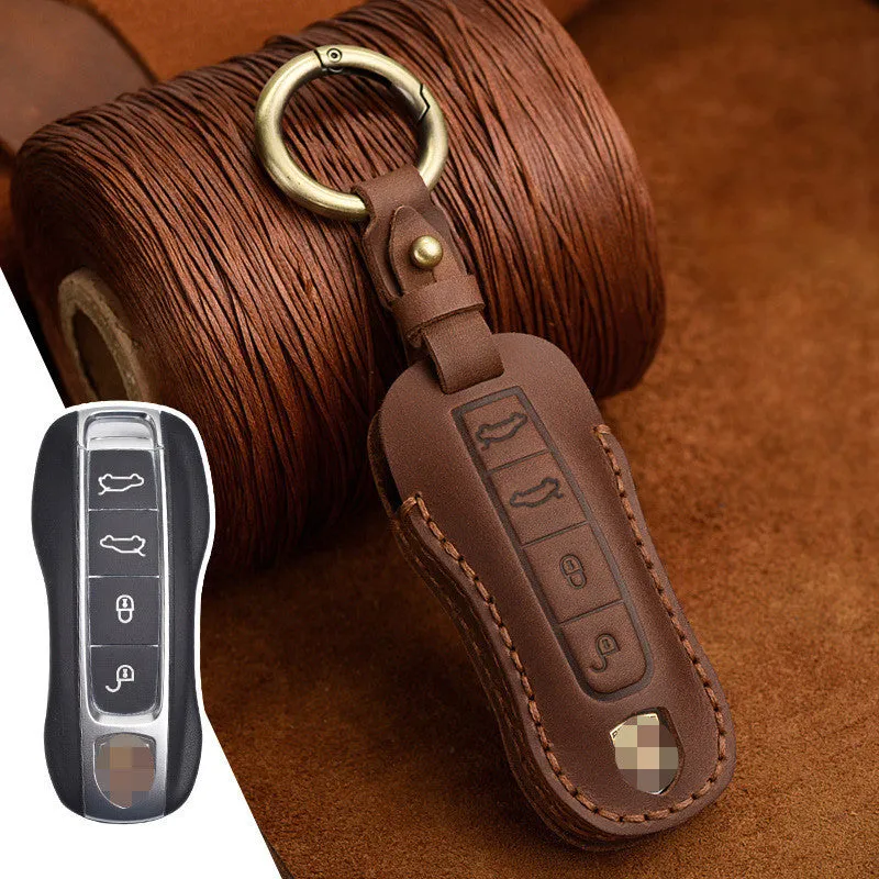 Blue leather Porsche key case with metal bag buckle showing 3 keys inserted