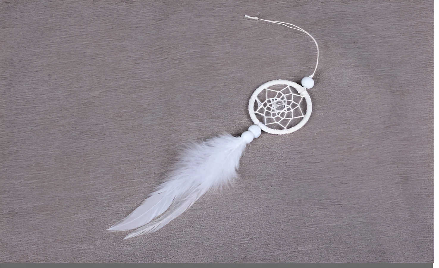 White mini dreamcatcher pendant 5cm on a wall as home decor