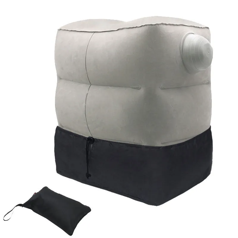 Gray inflatable foot pad with push-on button and adjustable storage bag containing travel accessories