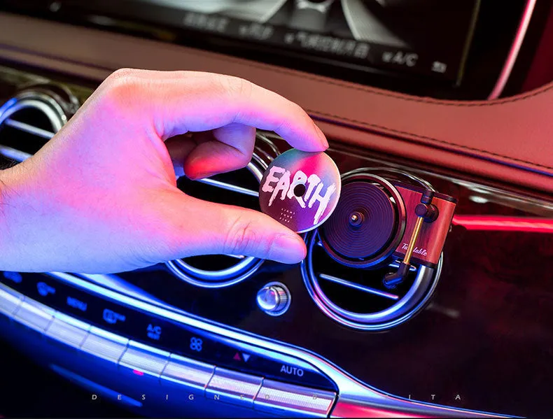 Brown alloy car perfume clip with record locomotive design on car air vent
