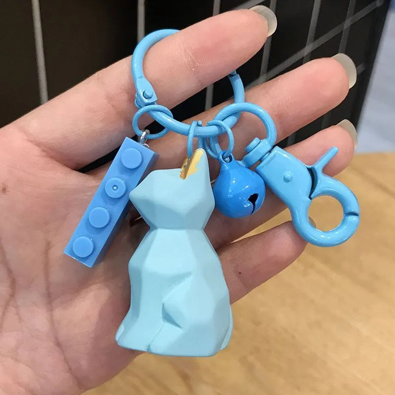 Acrylic geometric animal keychain in dinosaur style with colour buckle detail on a key ring