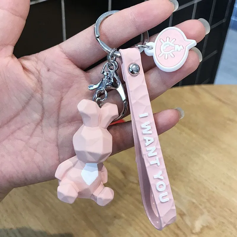 Acrylic geometric animal keychain in dinosaur style with colour buckle detail on a key ring