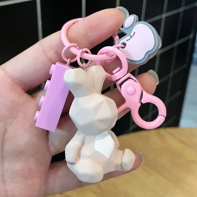 Acrylic geometric animal keychain in dinosaur style with colour buckle detail on a key ring