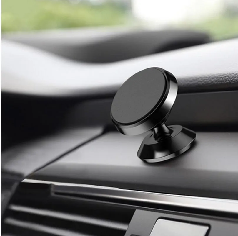 Magnetic car air outlet phone bracket in black attached to a vehicle vent