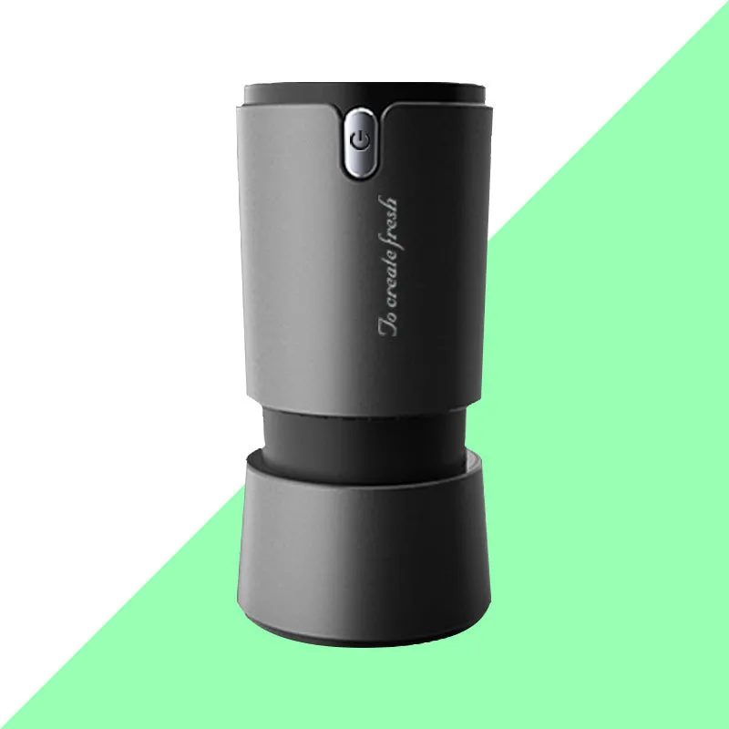 Portable mini car air purifier with True HEPA filter, USB cable, compact silver cup shape on car cup holder