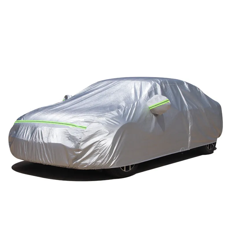 Silver-coated black taffeta universal car cover fitted over a sedan in outdoor parking