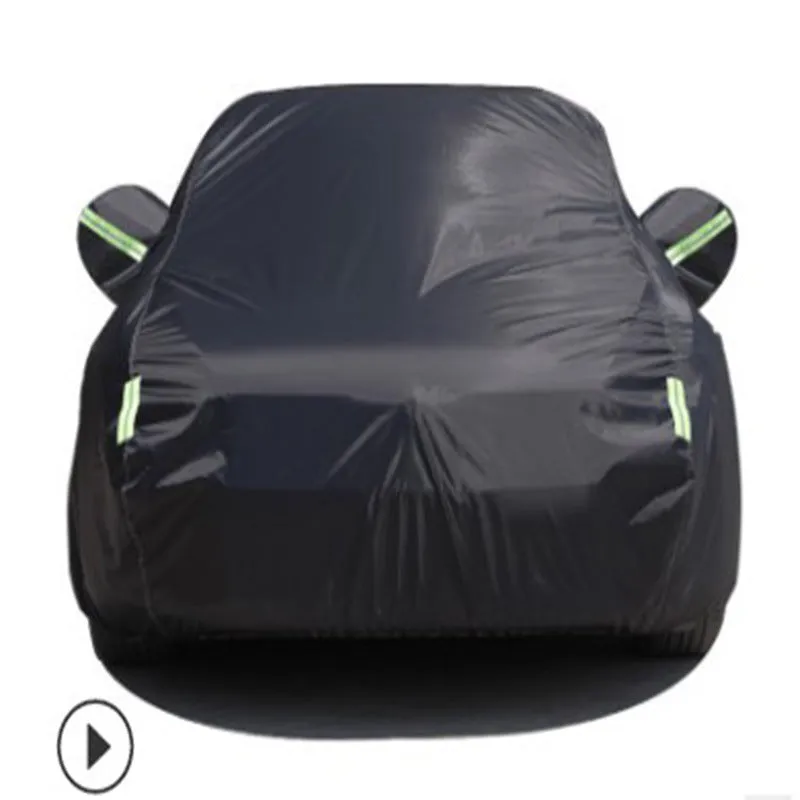 Silver-coated black taffeta universal car cover fitted over a sedan in outdoor parking