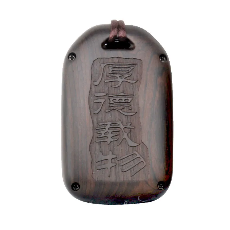 Solid ebony sandalwood key case with key rings, showing carved wood grain on a plain background