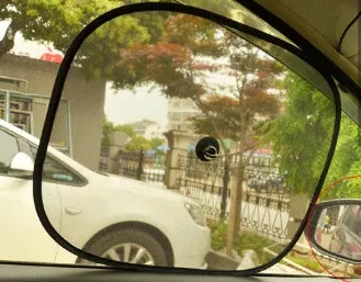 Black net yarn car sunshade sunscreen folded on car dashboard for glare reduction