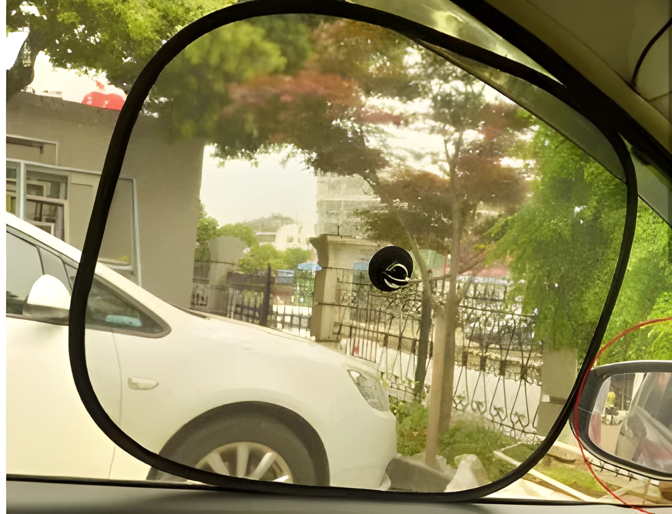 Black net yarn car sunshade sunscreen folded on car dashboard for glare reduction