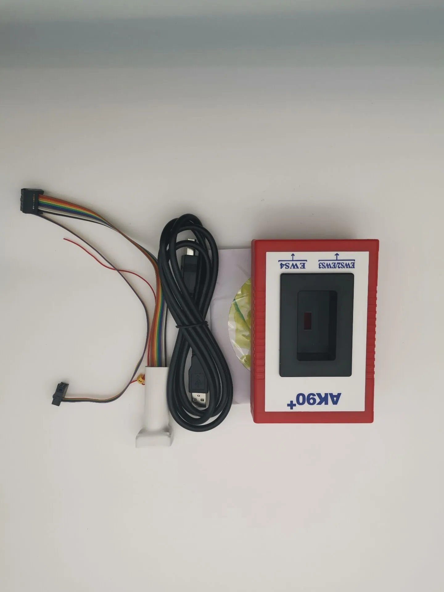 Red anti-theft key matching instrument car fault diagnosis tool on workshop bench