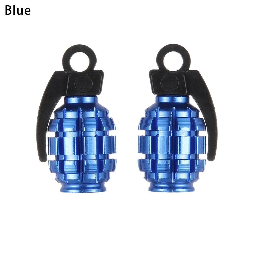 Two car tyre valve caps in blue and gold on a wheel rim