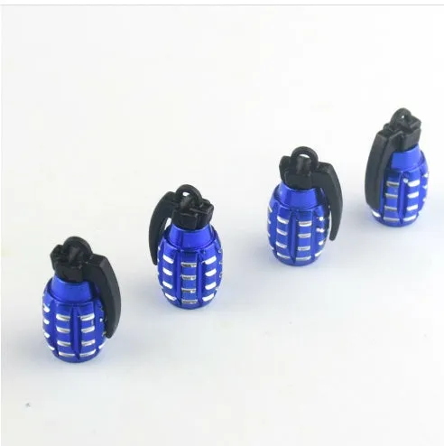 Two car tyre valve caps in blue and gold on a wheel rim