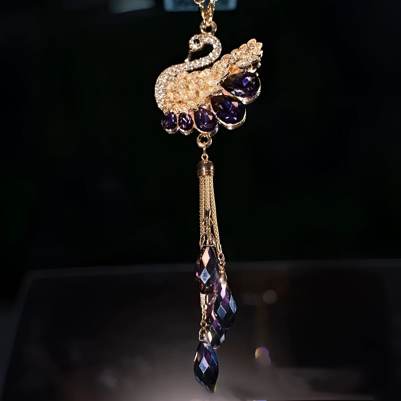 Double-sided crystal swan car pendant in blue metal and rhinestone, hanging from rearview mirror