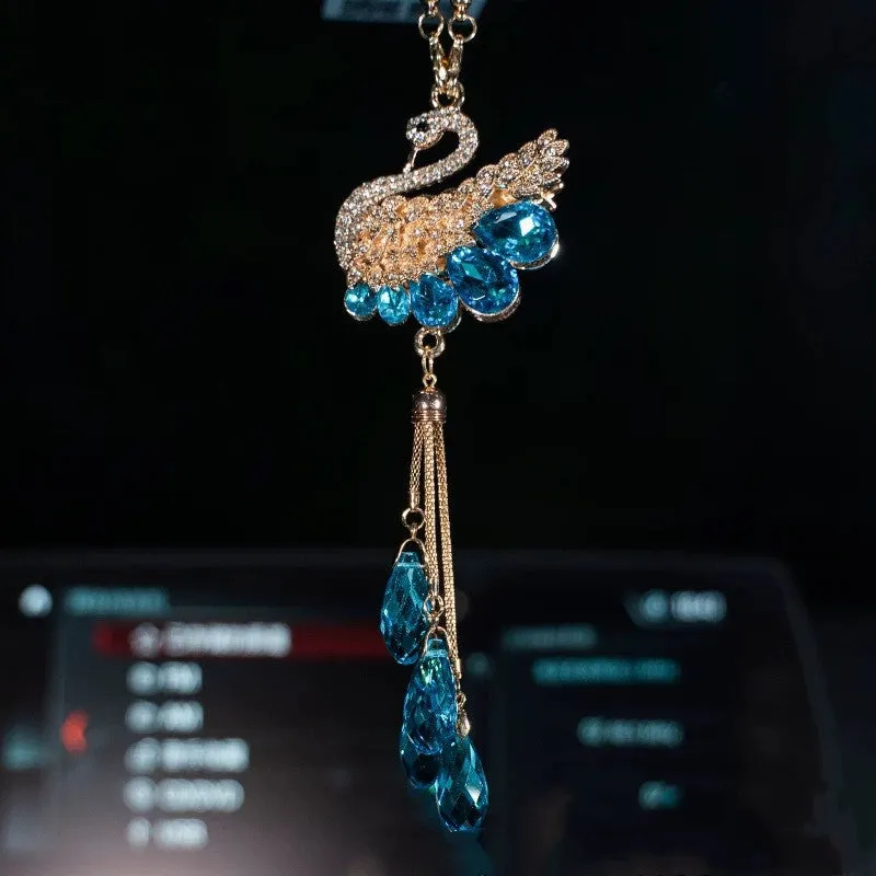 Double-sided crystal swan car pendant in blue metal and rhinestone, hanging from rearview mirror