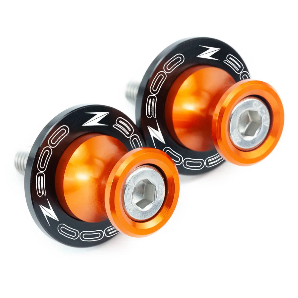 Pair of CNC aluminium swingarm spools for Kawasaki Z650 Z900 in anodised colour, with Delrin sliders and stainless steel bolts