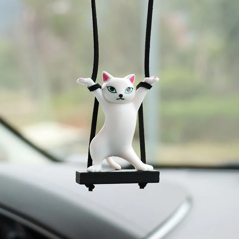 Cartoon-style resin cat pendant for car interior decoration in various colours with adjustable rope.
