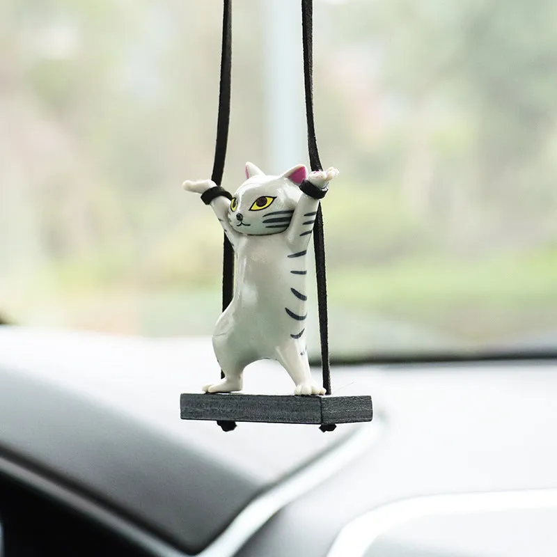 Cartoon-style resin cat pendant for car interior decoration in various colours with adjustable rope.