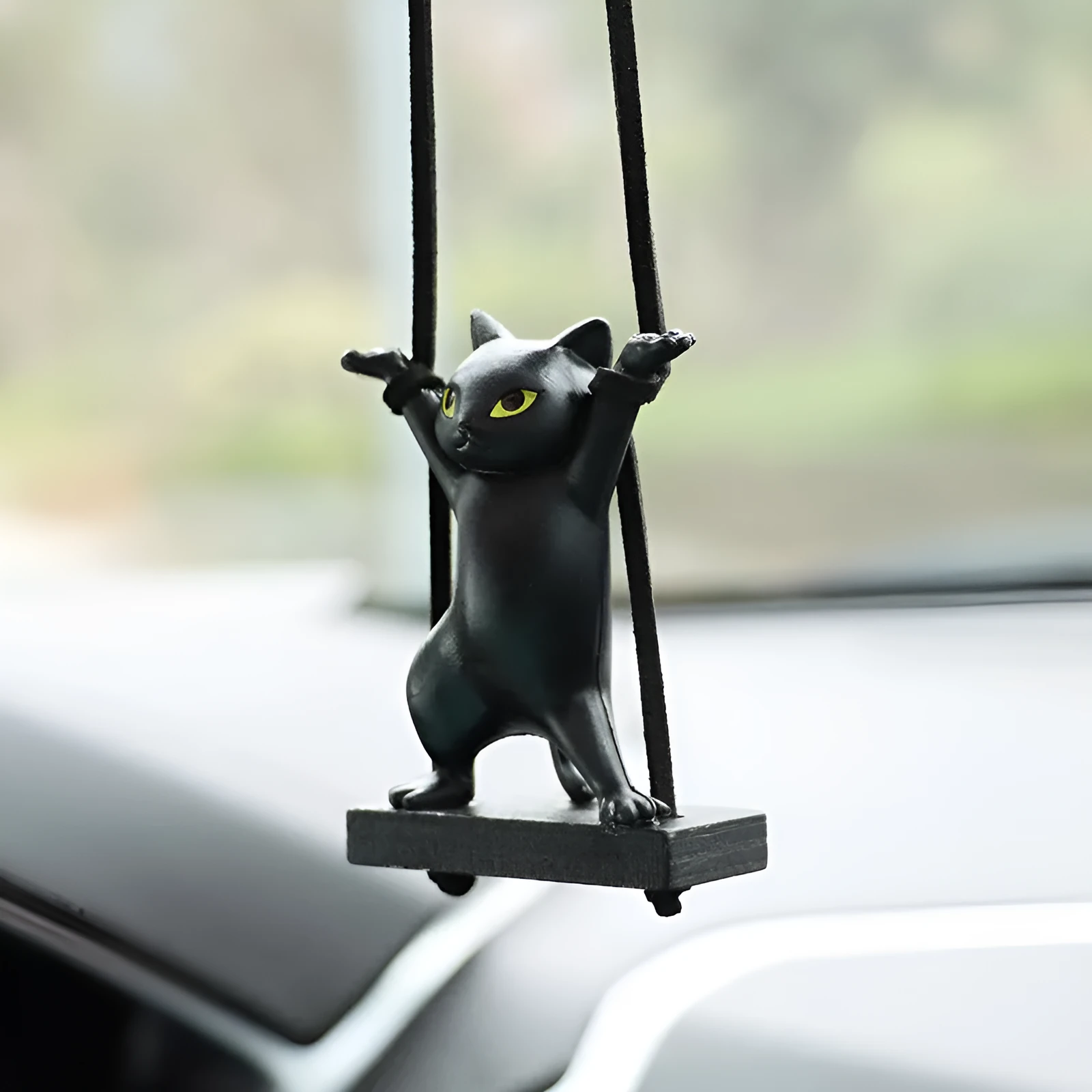 Cartoon-style resin cat pendant for car interior decoration in various colours with adjustable rope.