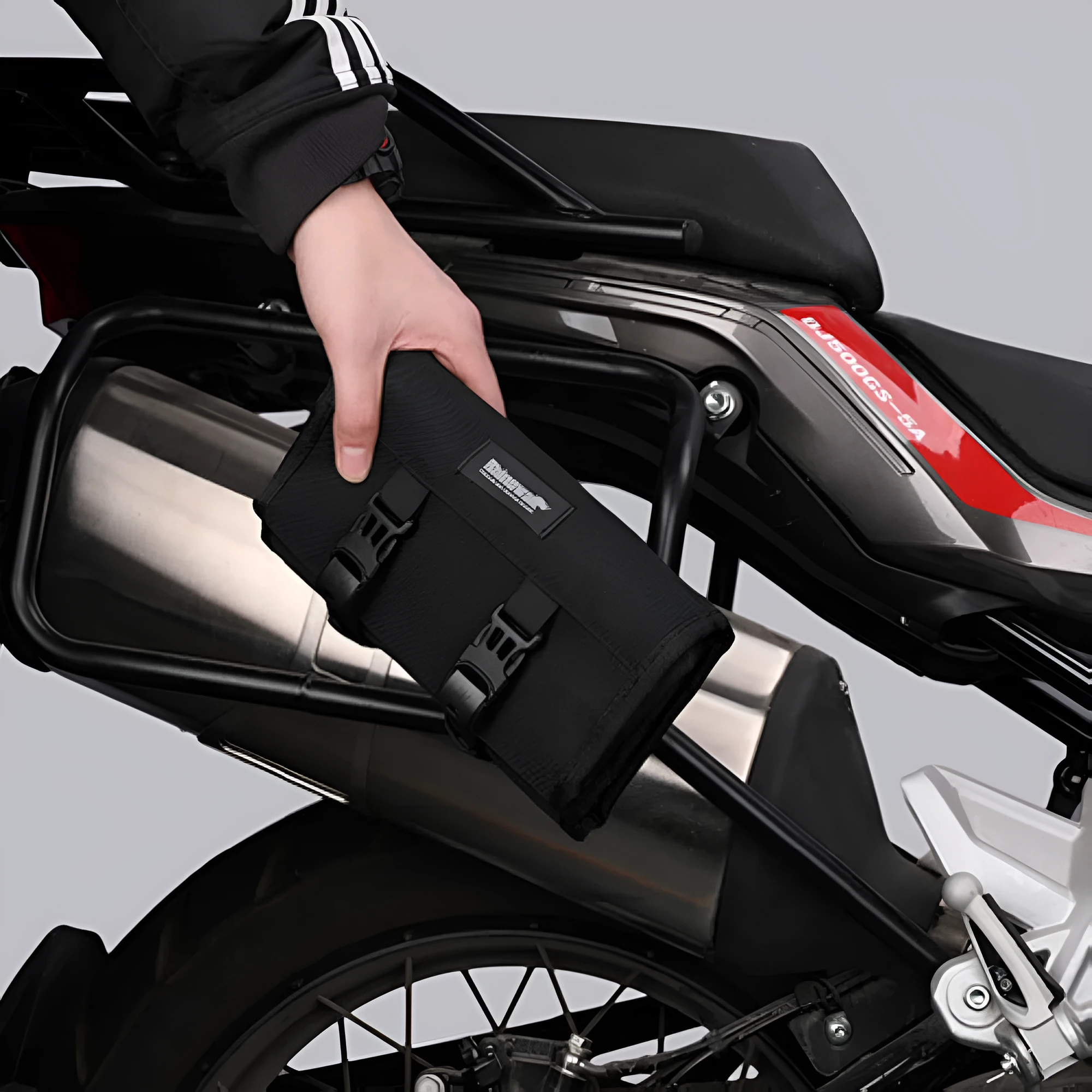 Motorcycle repair kit storage organiser in black, unfolded to show elastic straps and mesh zipper bag