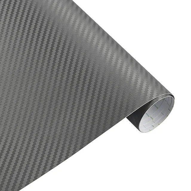 3D carbon fibre car sticker roll in black with textured pattern on a white background