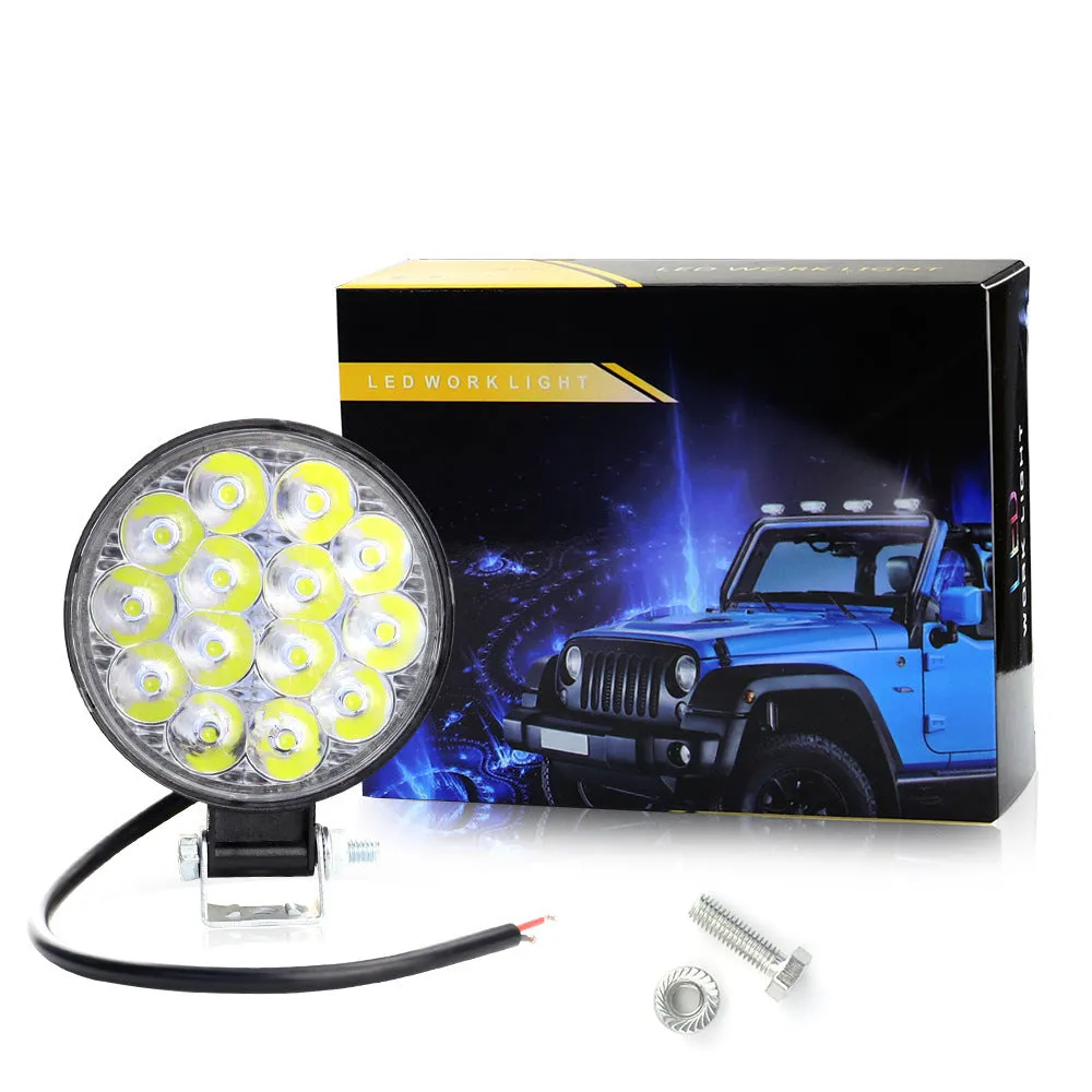 Compact round aluminium LED work light with white light, suitable for vehicle mounting.