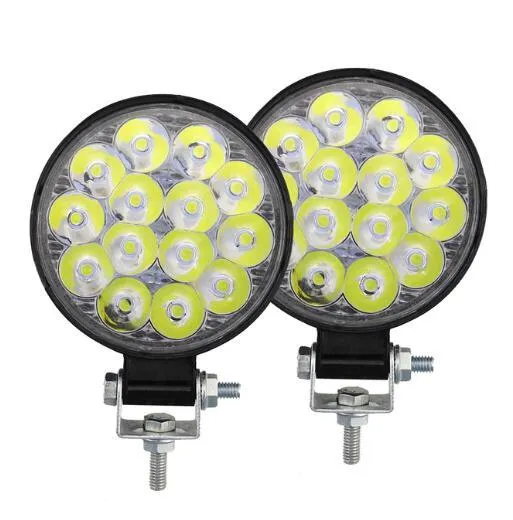 Compact round aluminium LED work light with white light, suitable for vehicle mounting.