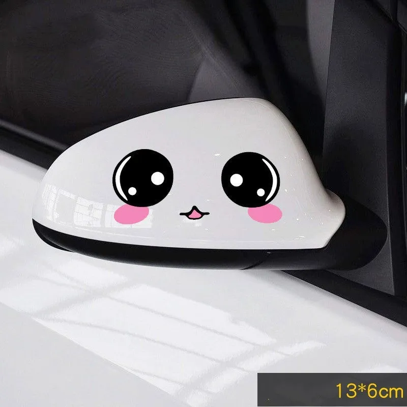 Pair of reflective cartoon car stickers with cute eyes on a car rearview mirror.