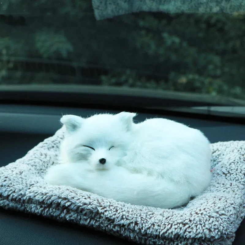 Fox bamboo charcoal car deodorant doll with grey hair and check pad on a car dashboard