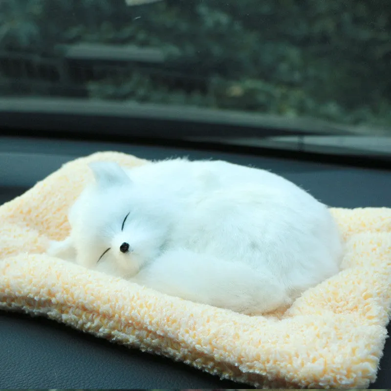 Fox bamboo charcoal car deodorant doll with grey hair and check pad on a car dashboard
