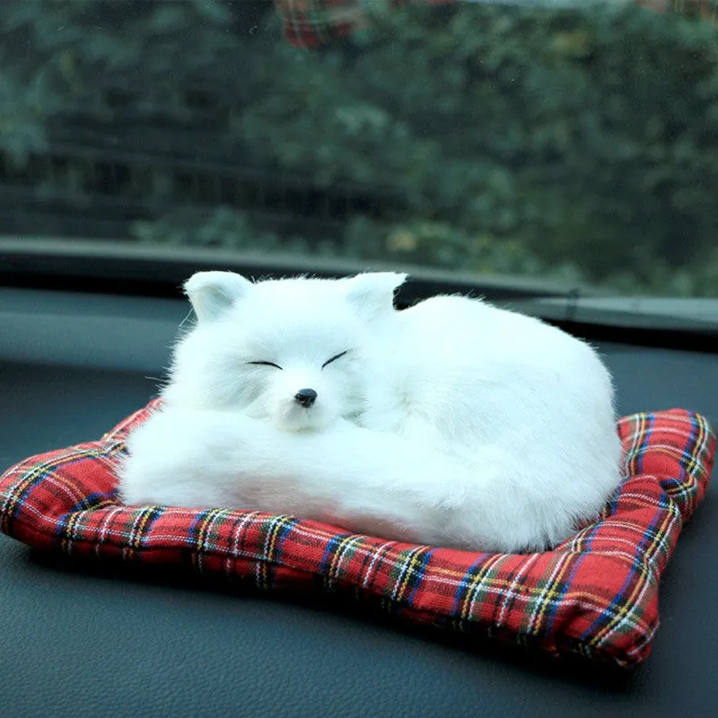 Fox bamboo charcoal car deodorant doll with grey hair and check pad on a car dashboard