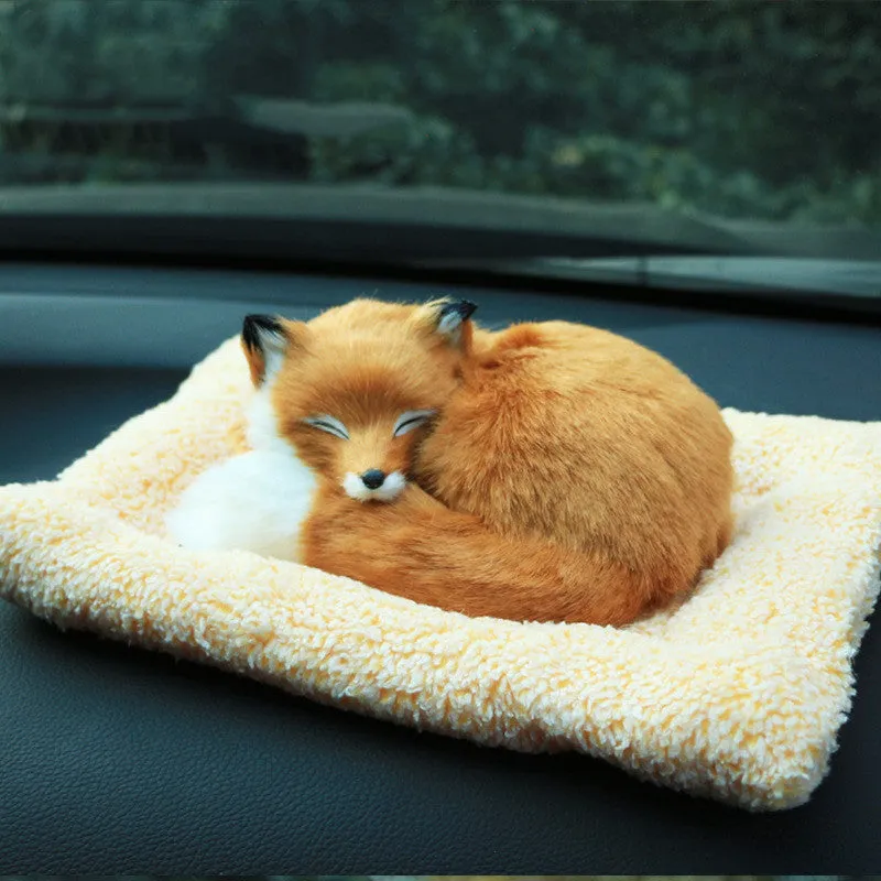 Fox bamboo charcoal car deodorant doll with grey hair and check pad on a car dashboard
