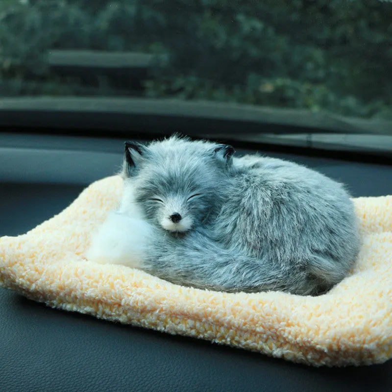 Fox bamboo charcoal car deodorant doll with grey hair and check pad on a car dashboard