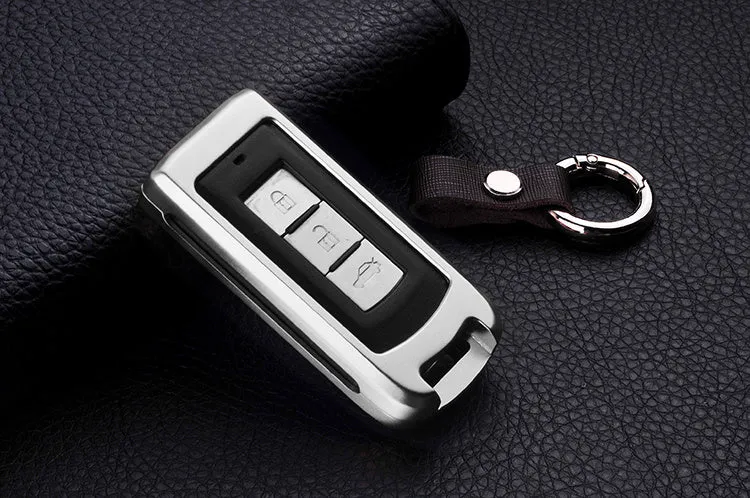 Aluminium alloy key shell sleeve buckle cover for car key protection in silver with cowhide leather accent