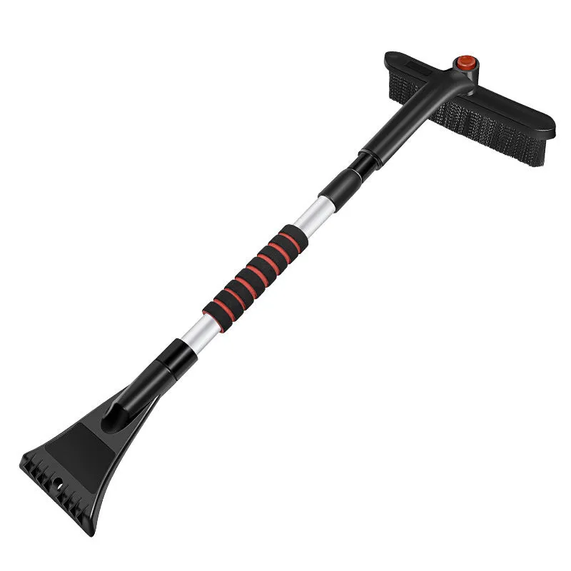 Car deicing shovel with black ABS plastic shovel head and brush, telescopic handle extended, on a windscreen with frost