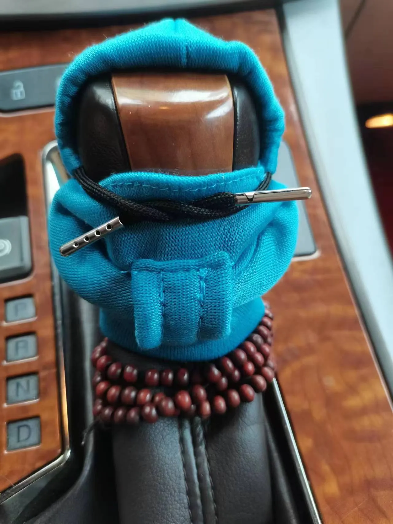 Dutch velvet car gear handle sleeve and handbrake cover in various colours on a car interior.