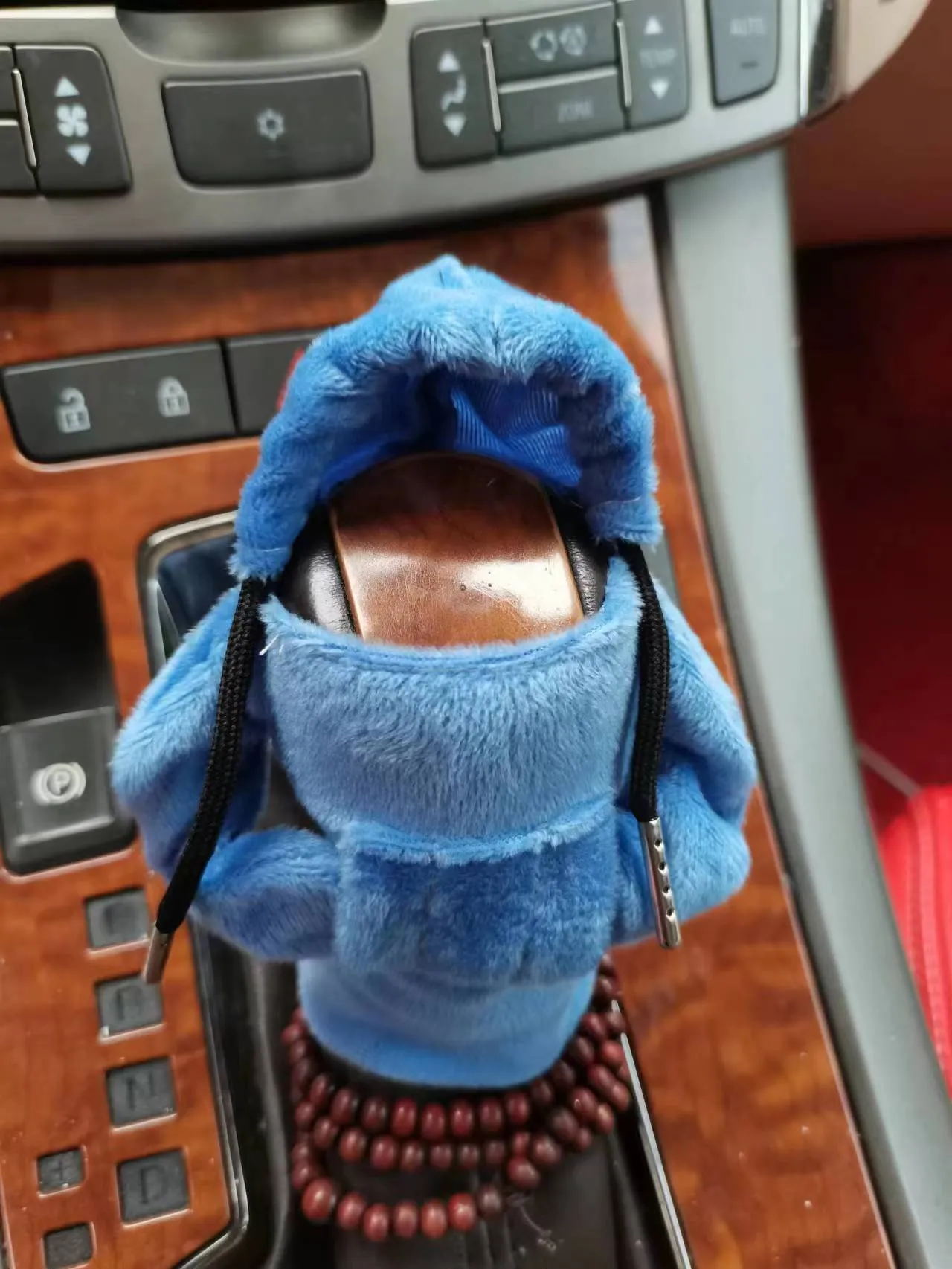 Dutch velvet car gear handle sleeve and handbrake cover in various colours on a car interior.