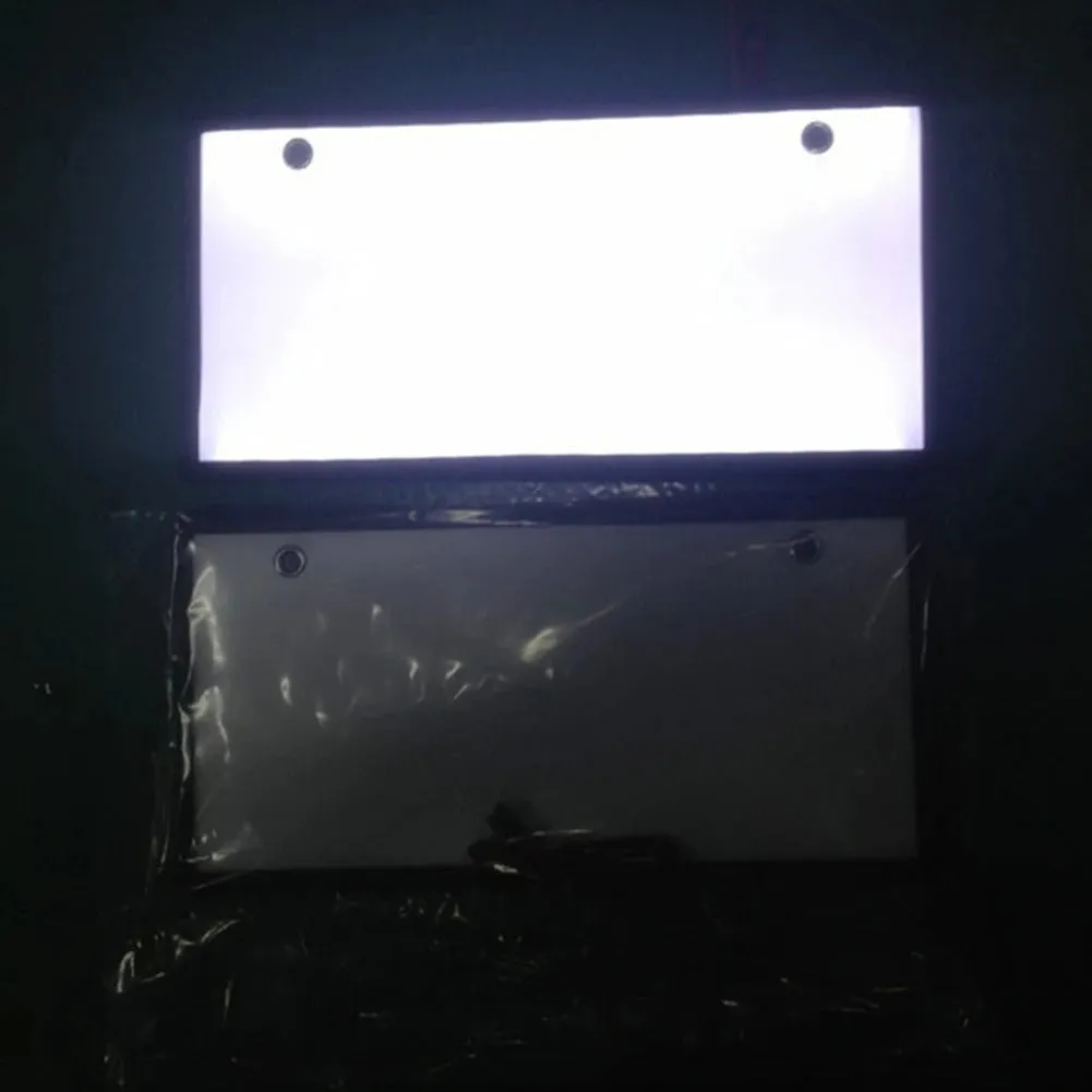 Two white LED truck licence plate lights with flat thin plastic housings and visible LED lamp bars.