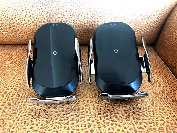 Black 15W smart car phone holder with wireless charging and infrared sensor on car dashboard