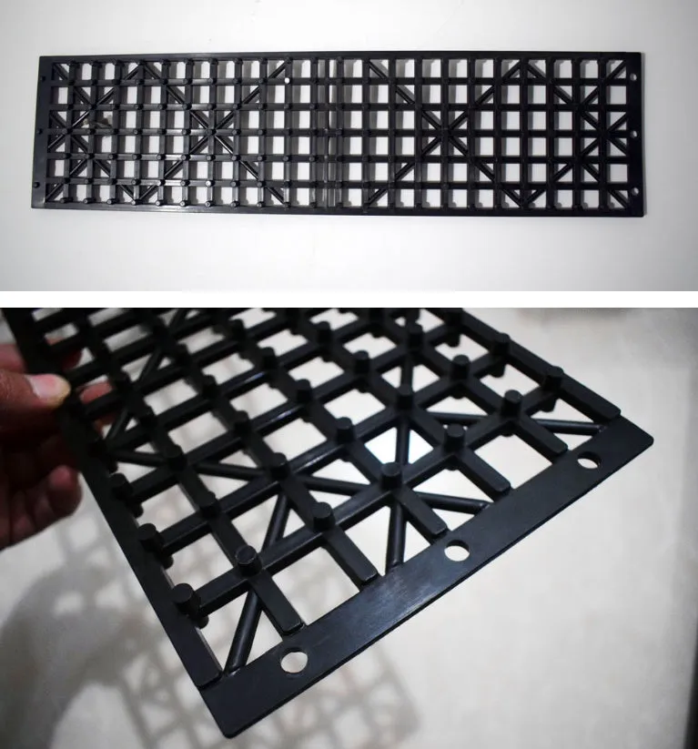 Pair of black rubber car recovery plates on a muddy ground, each 55×15 cm, for self-rescue from soft terrain