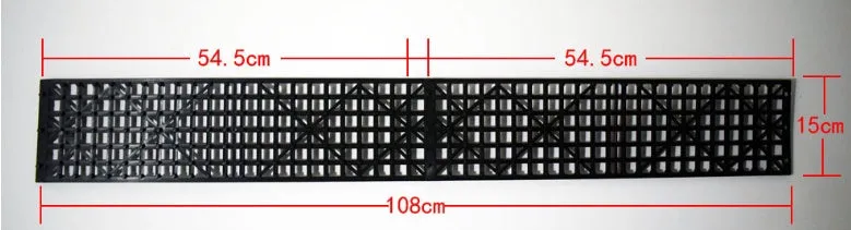 Pair of black rubber car recovery plates on a muddy ground, each 55×15 cm, for self-rescue from soft terrain